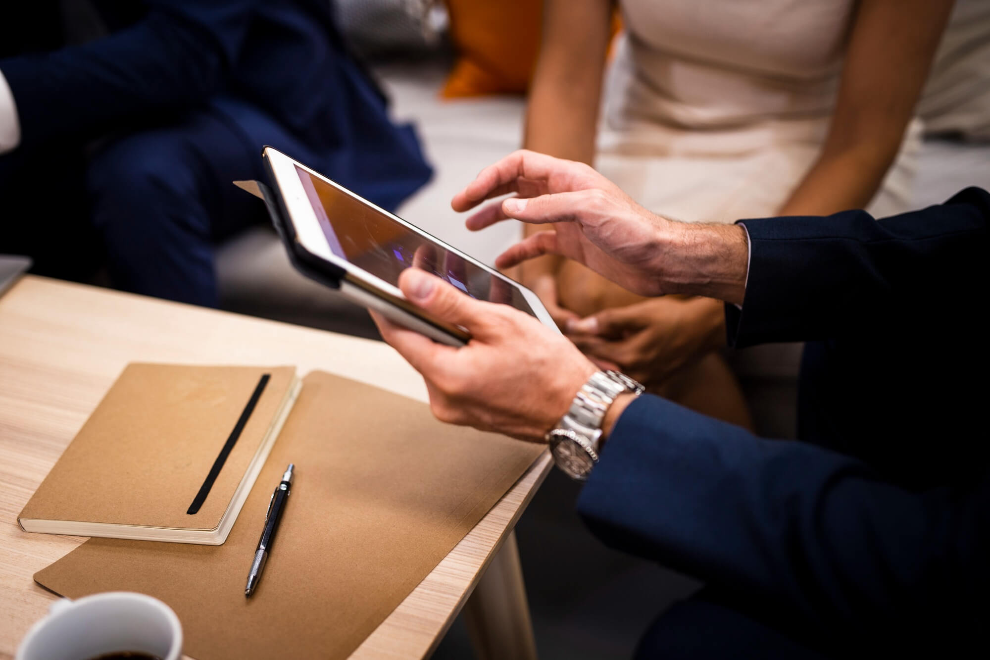 Person with a tablet showing it to customers