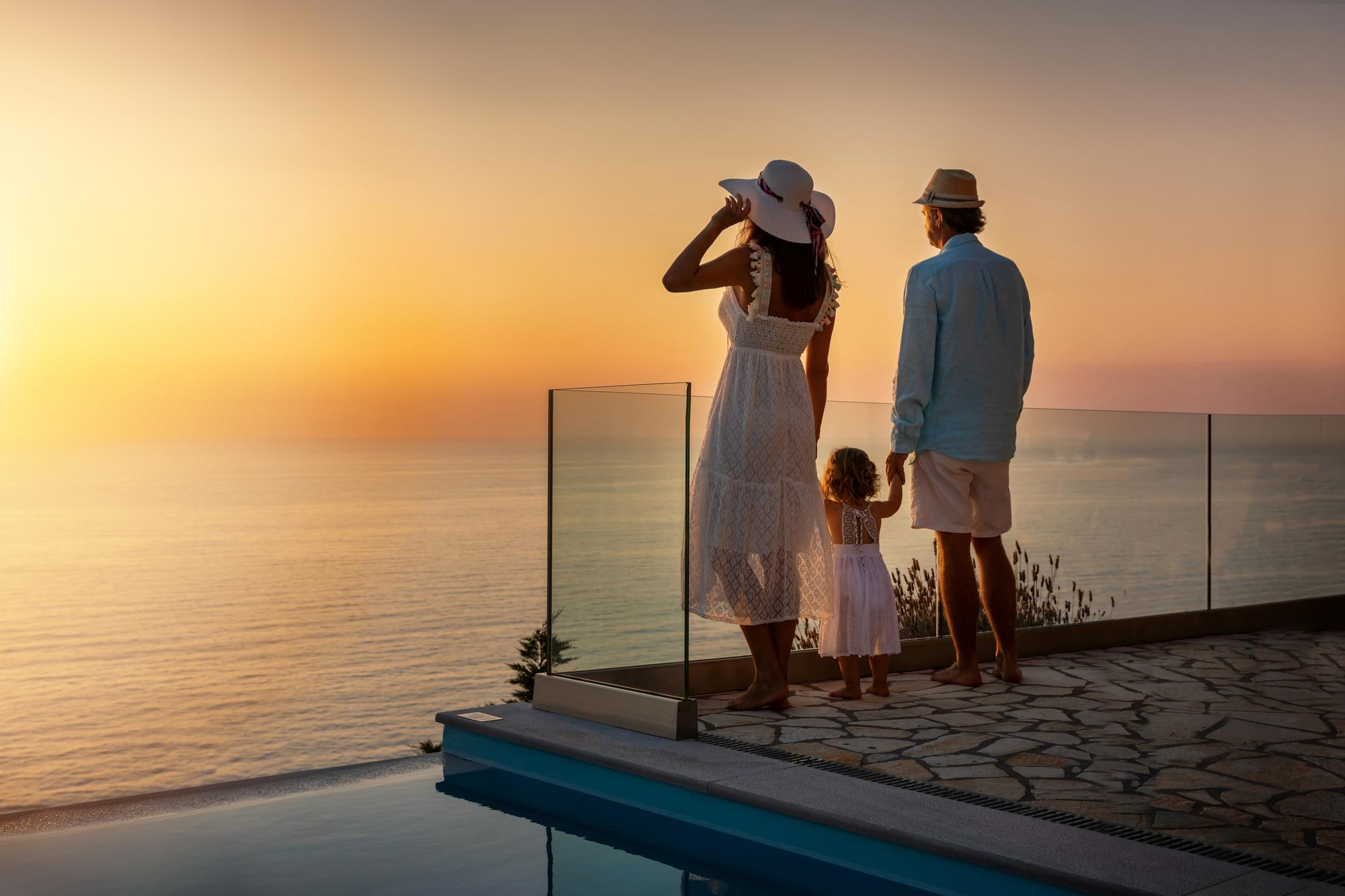 Family watching the sunset on a terrace