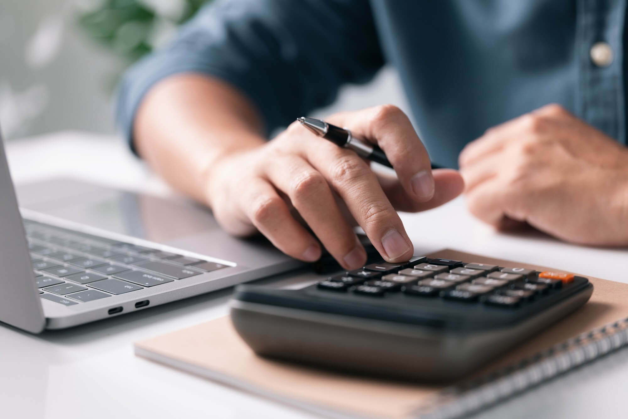 Person doing calculations with a calculator
